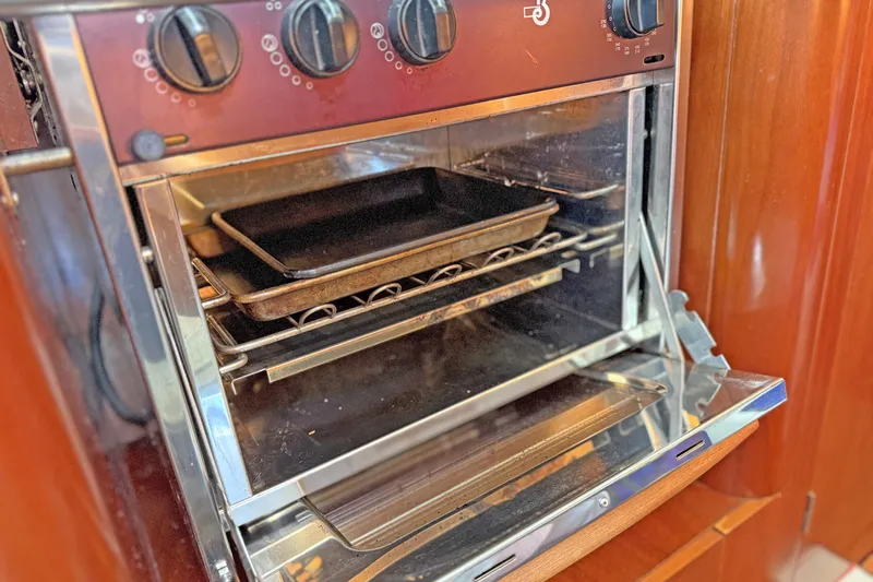 Bellabeaupied Yacht Photos Pics Oven inside a 2004 Beneteau 473 yacht, featuring baking trays and control knobs.