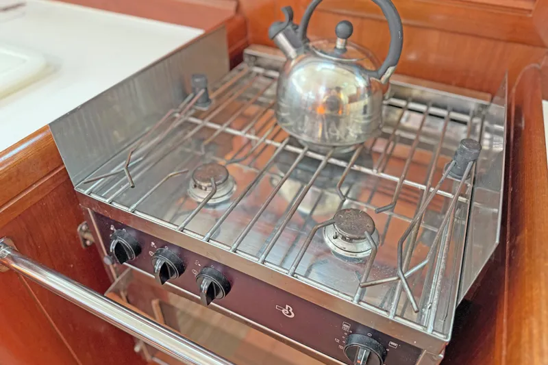 Bellabeaupied Yacht Photos Pics Stainless steel stove with kettle in 2004 Beneteau 473 yacht kitchen.