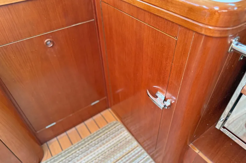Bellabeaupied Yacht Photos Pics Wooden cabinetry inside a 2004 Beneteau 473 yacht, featuring polished finish and metal handle.