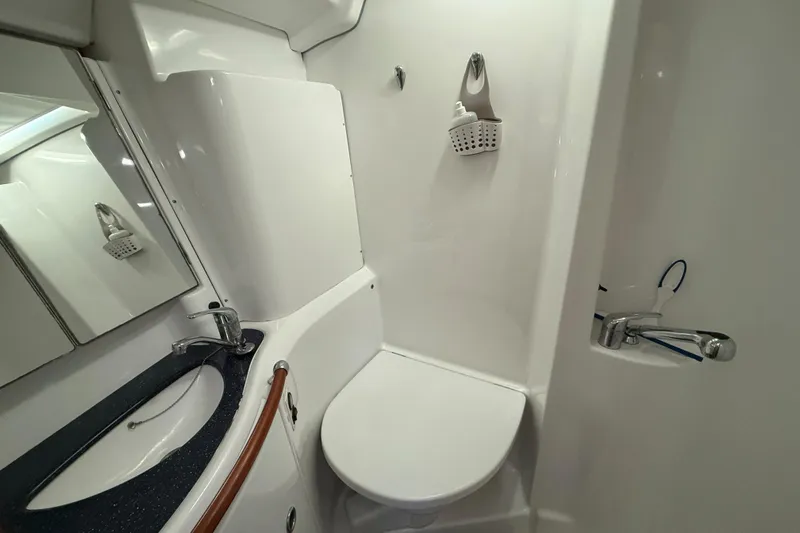 Bellabeaupied Yacht Photos Pics 2004 Beneteau 473 yacht bathroom with sink, mirror, and shower area.