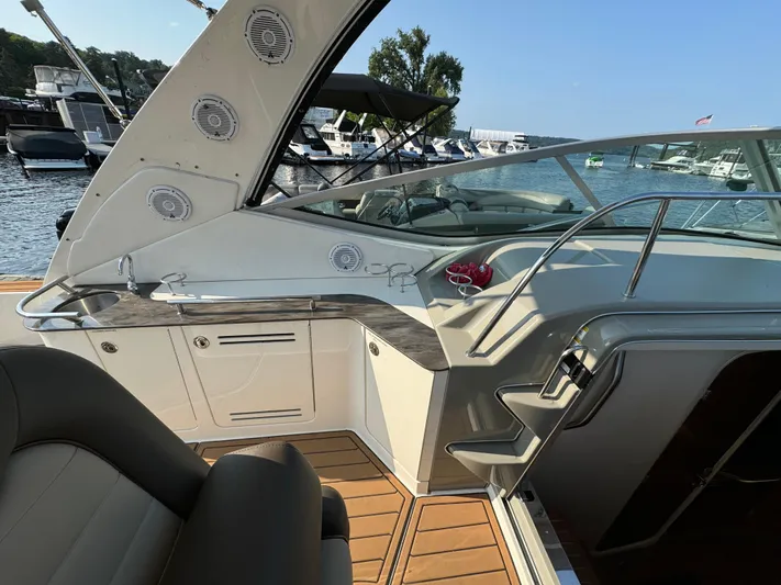  Yacht Photos Pics 2014 Sea Ray 330 Sundancer boat interior with seating, dashboard, and marina view.