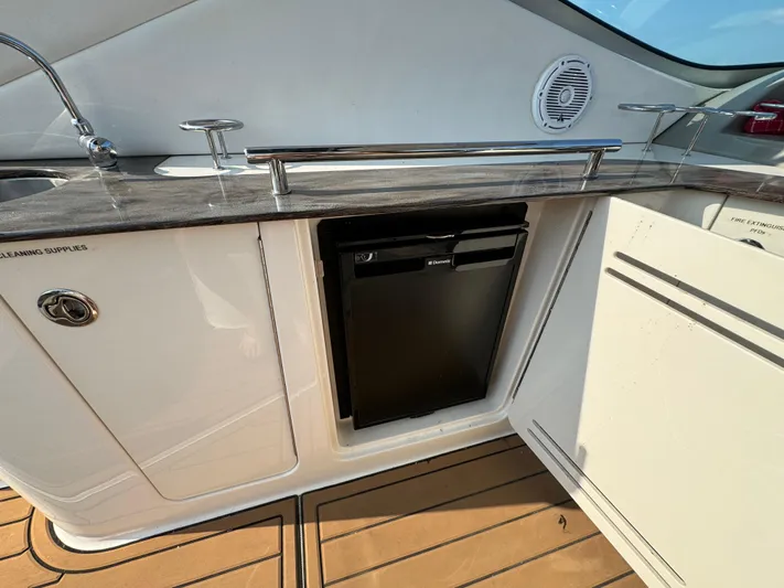  Yacht Photos Pics 2014 Sea Ray 330 Sundancer boat kitchenette with fridge and sleek countertop.