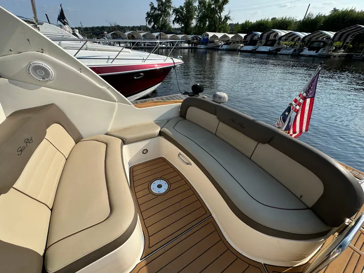  Yacht Photos Pics 2014 Sea Ray 330 Sundancer boat with beige seating, docked by a marina.