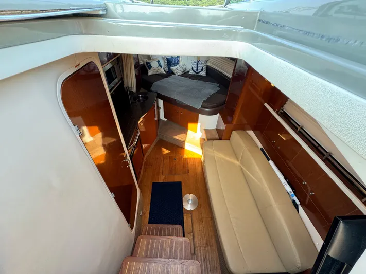  Yacht Photos Pics Interior of 2014 Sea Ray 330 Sundancer yacht with seating and kitchenette.