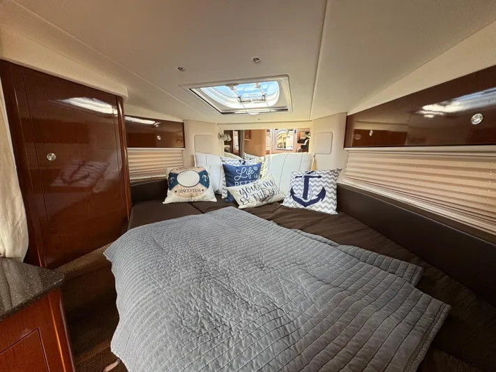  Yacht Photos Pics 2014 Sea Ray 330 Sundancer cabin with cozy bedding and nautical-themed pillows.