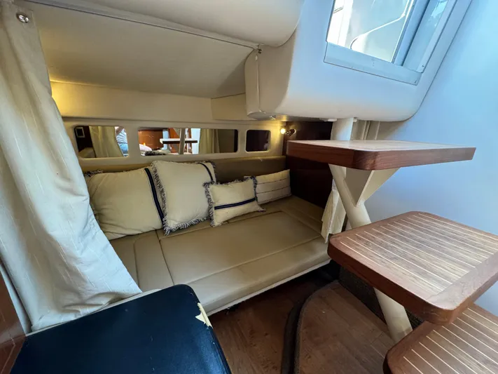  Yacht Photos Pics 2014 Sea Ray 330 Sundancer cabin interior with cozy seating and wooden table.
