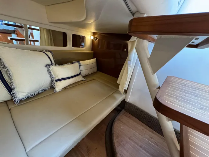  Yacht Photos Pics 2014 Sea Ray 330 Sundancer cabin interior with beige seating and decorative pillows.