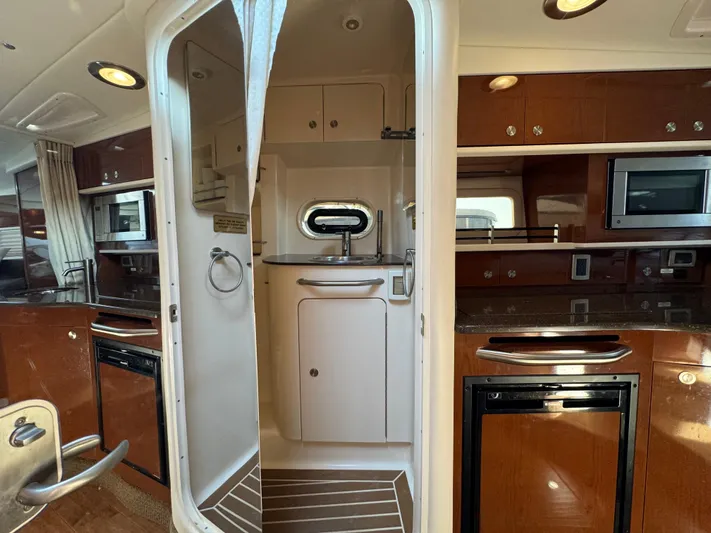  Yacht Photos Pics Interior of 2014 Sea Ray 330 Sundancer yacht with kitchenette and bathroom.