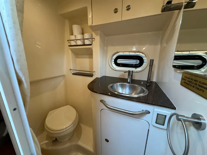  Yacht Photos Pics 2014 Sea Ray 330 Sundancer bathroom with sink, toilet, and storage shelves.