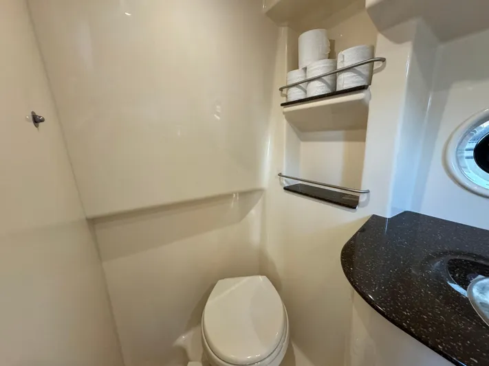  Yacht Photos Pics 2014 Sea Ray 330 Sundancer bathroom with toilet, shelves, and porthole window.