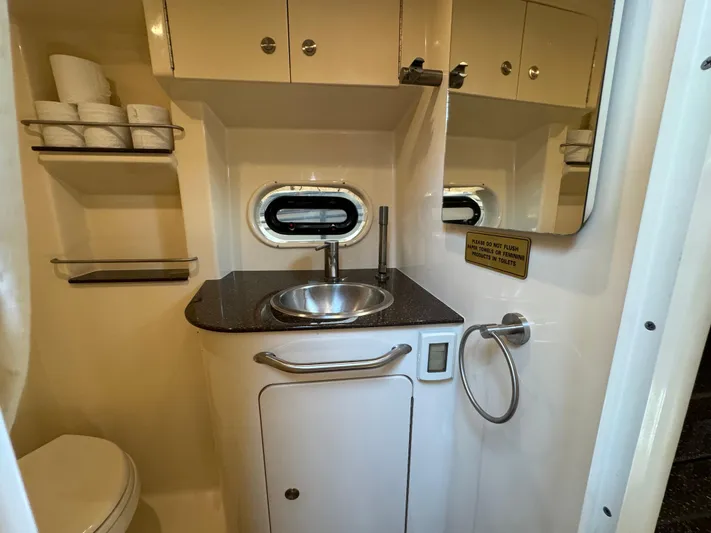  Yacht Photos Pics 2014 Sea Ray 330 Sundancer bathroom with sink, mirror, and storage shelves.