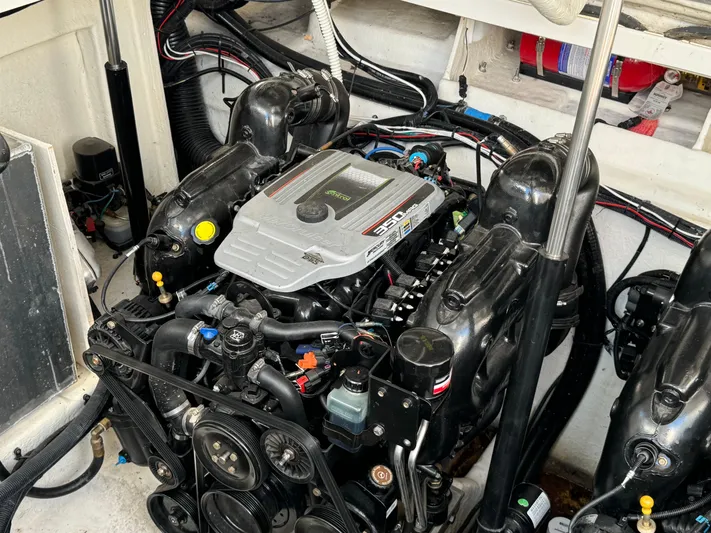  Yacht Photos Pics Engine compartment of a 2014 Sea Ray 330 Sundancer boat, showcasing detailed mechanical components.
