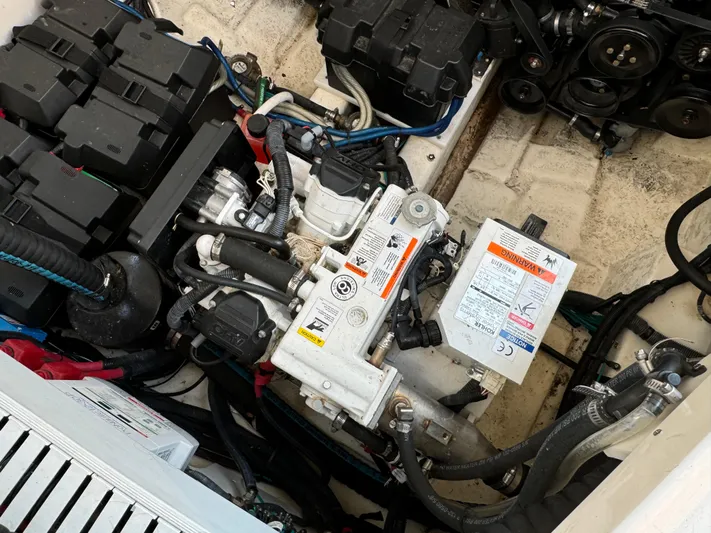  Yacht Photos Pics Engine compartment of a 2014 Sea Ray 330 Sundancer boat, showcasing mechanical components.