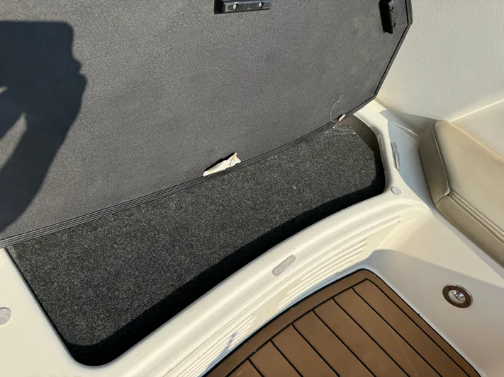  Yacht Photos Pics 2014 Sea Ray 330 Sundancer storage compartment with carpeted interior and teak flooring.