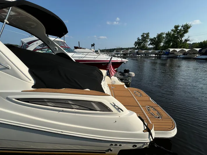  Yacht Photos Pics 2014 Sea Ray 330 Sundancer docked at marina, sunny day, calm water, nearby boats.