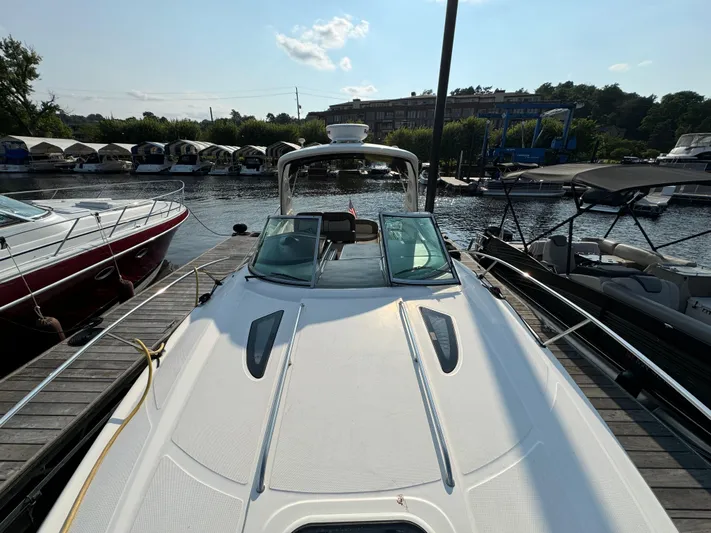  Yacht Photos Pics 2014 Sea Ray 330 Sundancer docked at marina, sunny day, surrounded by other boats.