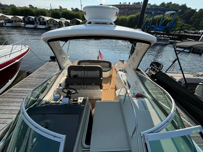  Yacht Photos Pics 2014 Sea Ray 330 Sundancer docked, showcasing spacious deck and seating area.