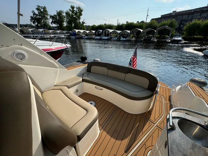  Yacht Photos Pics 2014 Sea Ray 330 Sundancer boat with seating area, docked by a marina.