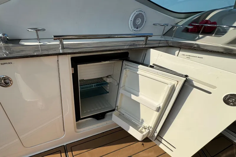  Yacht Photos Pics Open mini fridge on 2014 Sea Ray 330 Sundancer yacht, showcasing sleek interior design.
