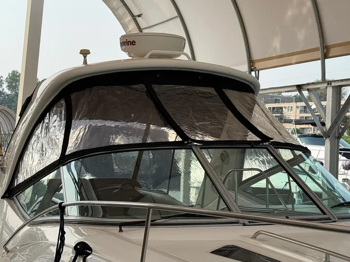  Yacht Photos Pics 2014 Sea Ray 330 Sundancer boat with covered windshield in a marina.