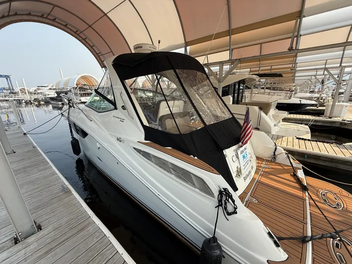  Yacht Photos Pics 2014 Sea Ray 330 Sundancer docked under a canopy at a marina.