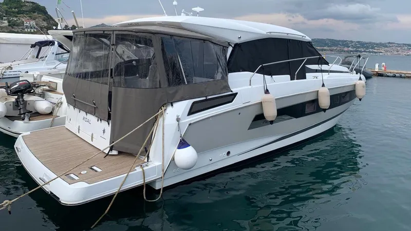  Yacht Photos Pics 2019 Jeanneau NC 37 yacht docked in a marina, featuring sleek design and modern amenities.