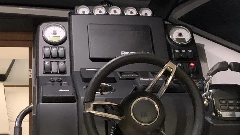  Yacht Photos Pics Control panel of a 2019 Jeanneau NC 37 boat with steering wheel and gauges.