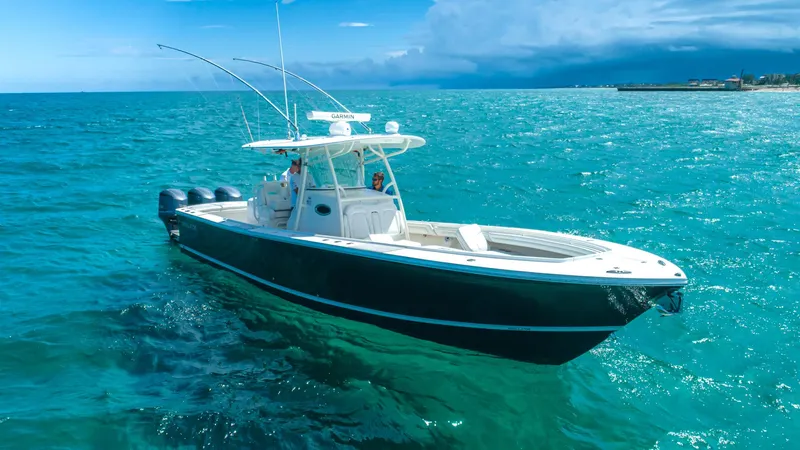  Yacht Photos Pics 2019 Regulator 34 boat cruising on clear blue ocean waters.