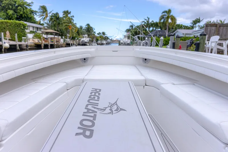  Yacht Photos Pics 2019 Regulator 34 boat interior with seating, docked in a tropical canal setting.