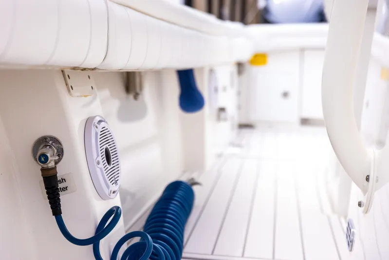  Yacht Photos Pics Interior view of 2019 Regulator 34 boat with coiled blue hose and speaker.