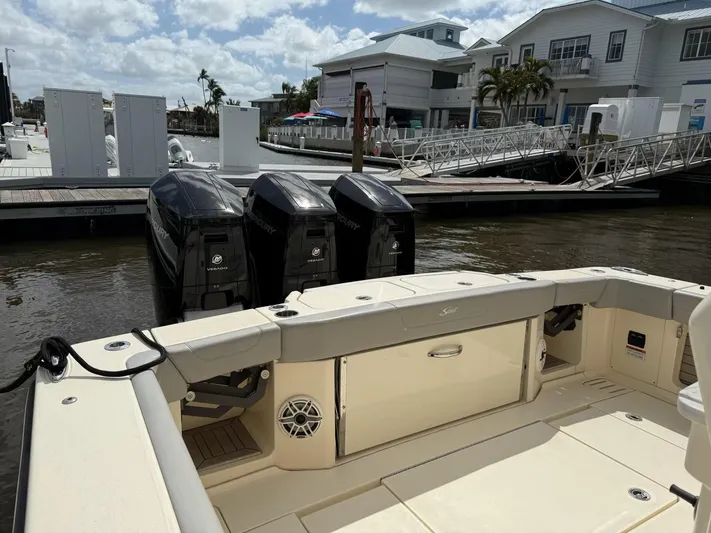  Yacht Photos Pics 2022 Scout 425 LXF boat with triple outboard engines docked at marina.