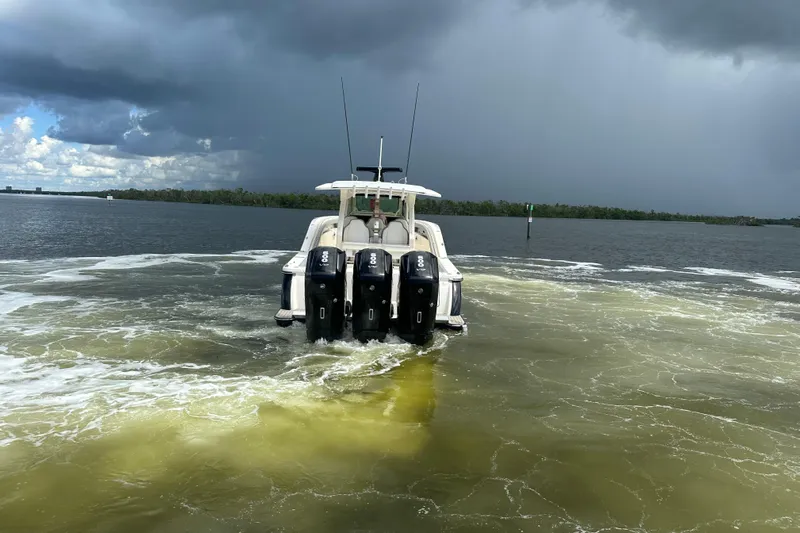  Yacht Photos Pics 2022 Scout 425 LXF boat with four engines on a cloudy day.