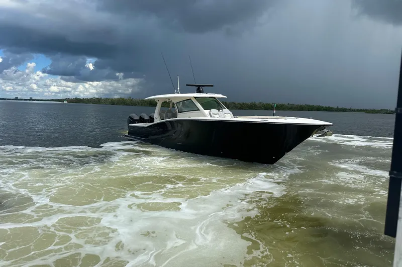  Yacht Photos Pics 2022 Scout 425 LXF boat cruising on a cloudy day.