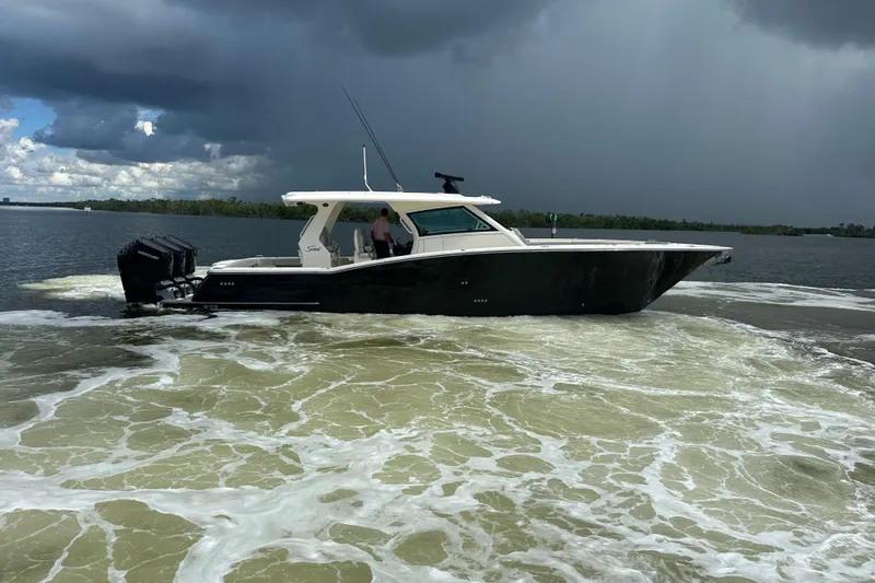  Yacht Photos Pics 2022 Scout 425 LXF boat cruising on a cloudy day.