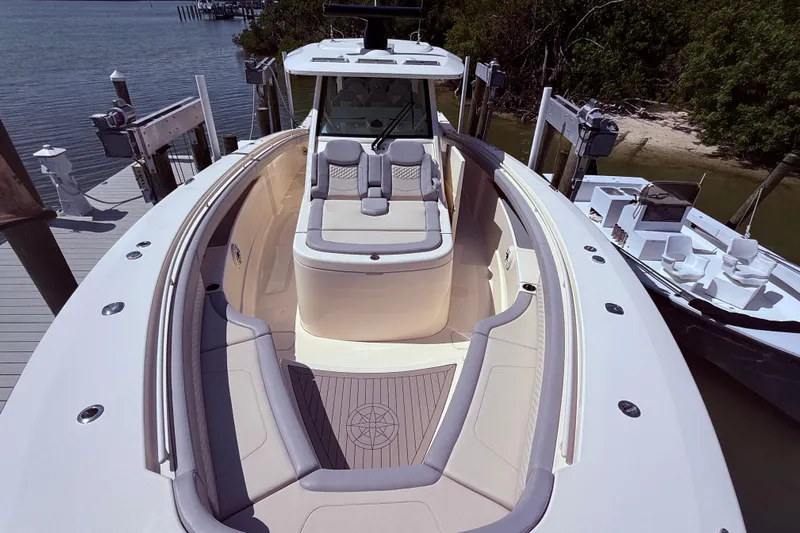 Yacht Photos Pics 2022 Scout 425 LXF luxury boat with spacious seating and elegant design at dock.