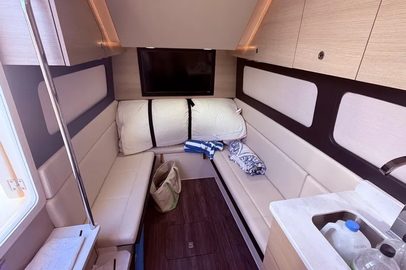  Yacht Photos Pics Luxurious interior of 2022 Scout 425 LXF boat with seating, TV, and kitchenette.