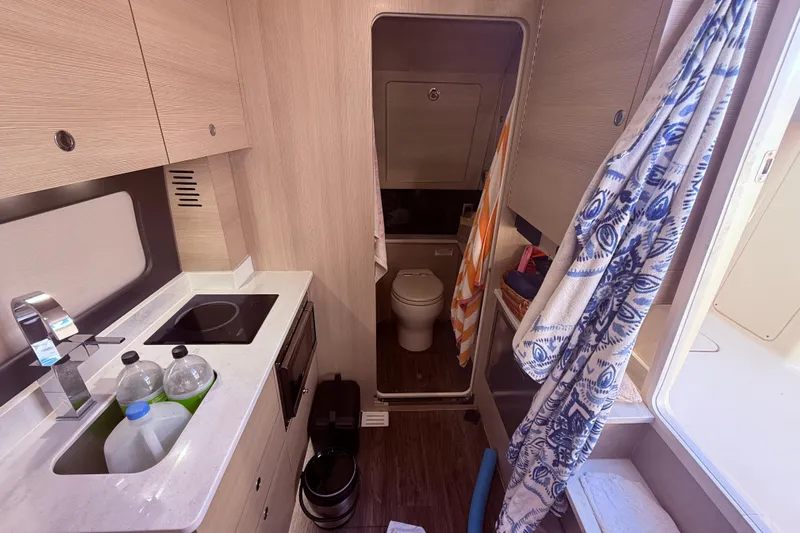  Yacht Photos Pics Luxurious interior of 2022 Scout 425 LXF boat with kitchenette and bathroom.