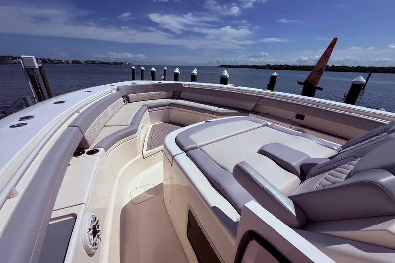  Yacht Photos Pics 2022 Scout 425 LXF luxury boat interior with plush seating and ocean view.