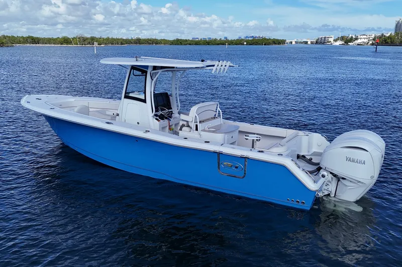  Yacht Photos Pics 2023 Sea Hunt Ultra 305 SE boat on calm water, featuring Yamaha engines.