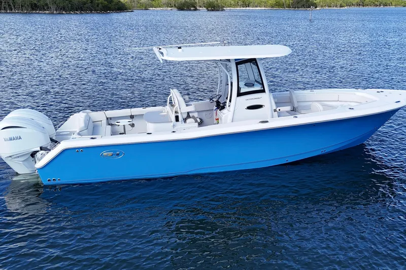  Yacht Photos Pics 2023 Sea Hunt Ultra 305 SE boat on calm water, featuring a sleek blue design.