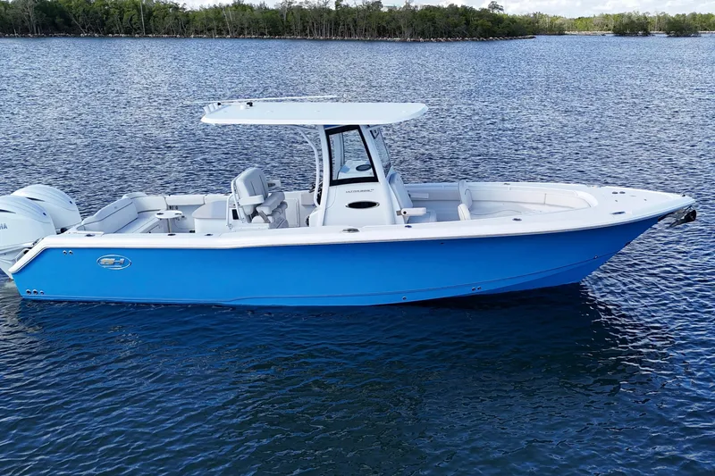  Yacht Photos Pics 2023 Sea Hunt Ultra 305 SE boat on calm water, featuring a sleek blue design.