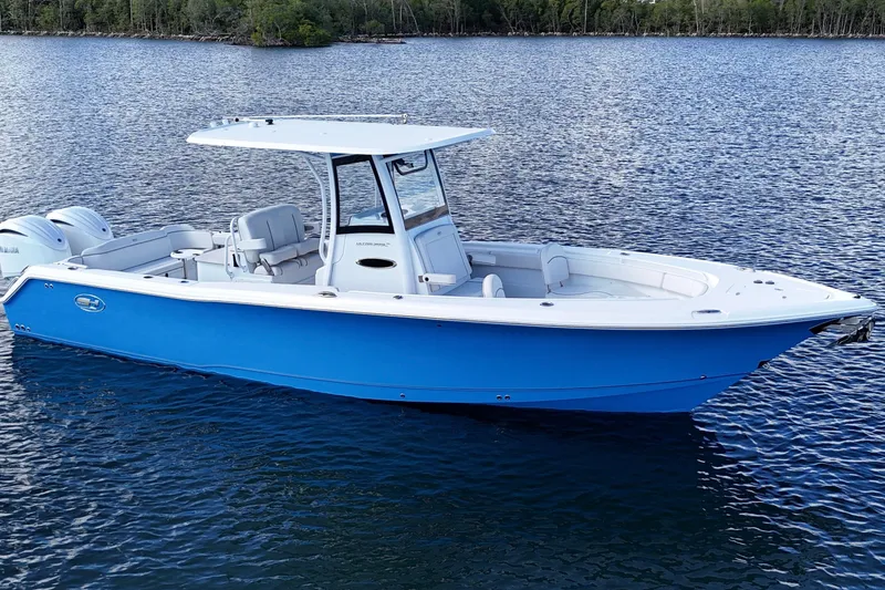  Yacht Photos Pics 2023 Sea Hunt Ultra 305 SE boat on calm water, featuring sleek blue design.