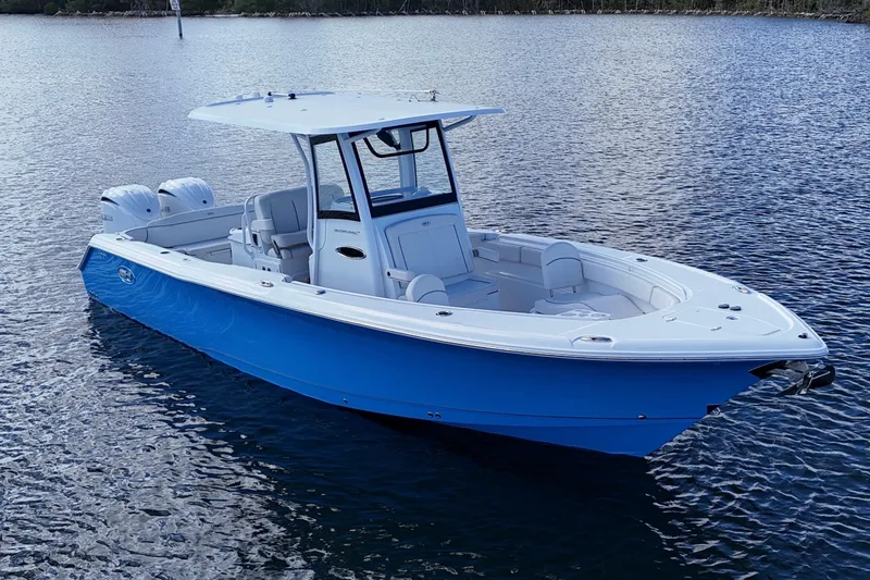  Yacht Photos Pics 2023 Sea Hunt Ultra 305 SE boat on calm water, featuring a sleek blue and white design.