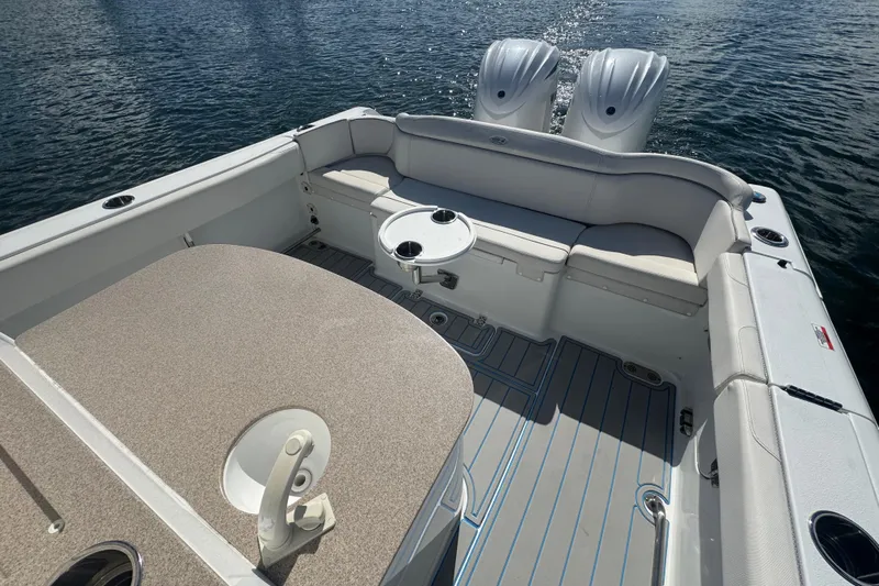  Yacht Photos Pics 2023 Sea Hunt Ultra 305 SE boat interior with seating and twin engines on water.