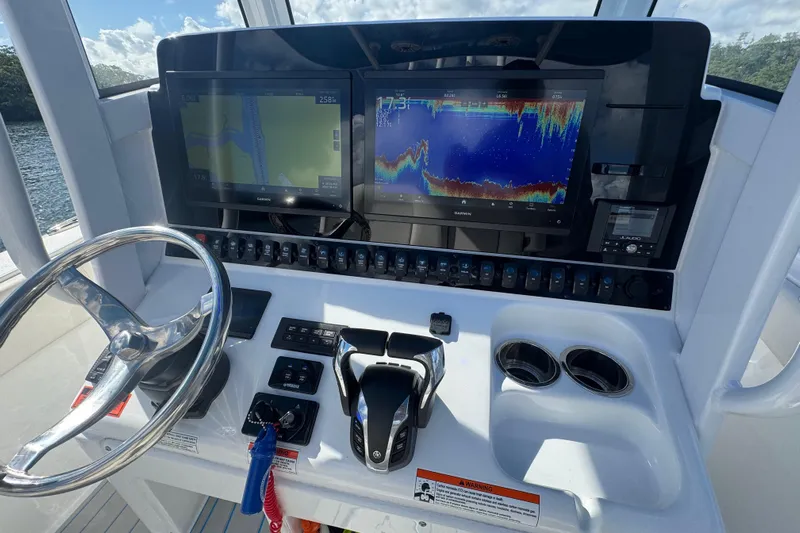  Yacht Photos Pics 2023 Sea Hunt Ultra 305 SE dashboard with dual Garmin displays and steering wheel.