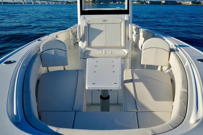 No Name 2024 30 Sea Hunt Yacht Photos Pics 2024 Sea Hunt 305 Ultra boat interior with seating and table on calm water.