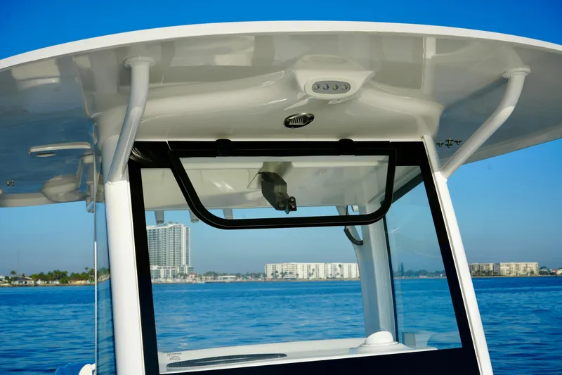 No Name 2024 30 Sea Hunt Yacht Photos Pics 2024 Sea Hunt 305 Ultra boat with T-top, on calm blue water.