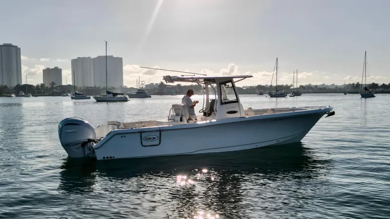 No Name 2024 30 Sea Hunt Yacht Photos Pics 2024 Sea Hunt 305 Ultra boat on calm water with city skyline in background.