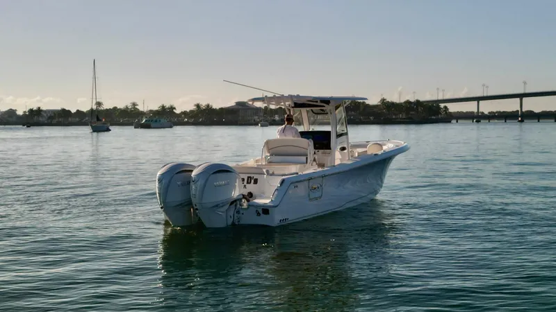 No Name 2024 30 Sea Hunt Yacht Photos Pics 2024 Sea Hunt 305 Ultra boat on calm water, featuring dual engines and sleek design.