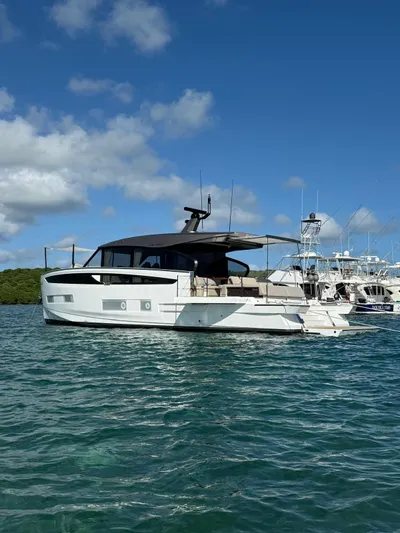  Yacht Photos Pics 2025 Azimut Seadeck 6 yacht on clear blue water under a sunny sky.